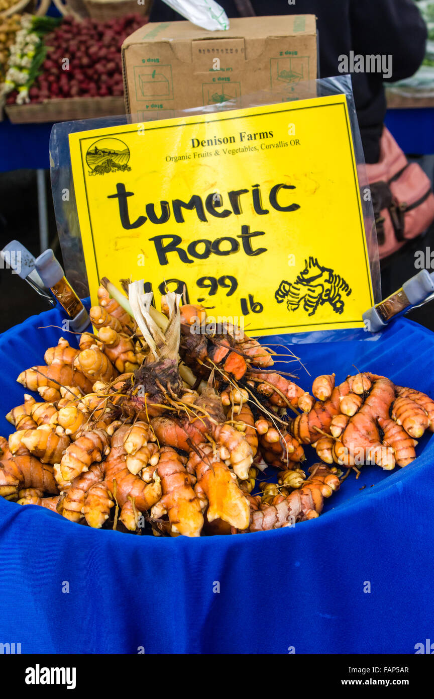 Fresh tumeric root displayed for sale at a market stall in the farmers market, Beaverton, Oregon, USA Stock Photo