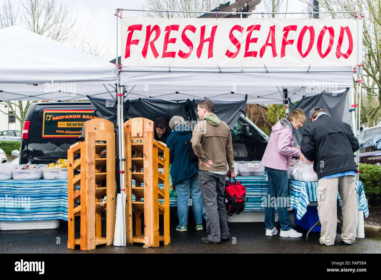 Customers shopping for fresh seafood at a fishmonger in the market, Beaverton, Oregon, USA Stock Photo