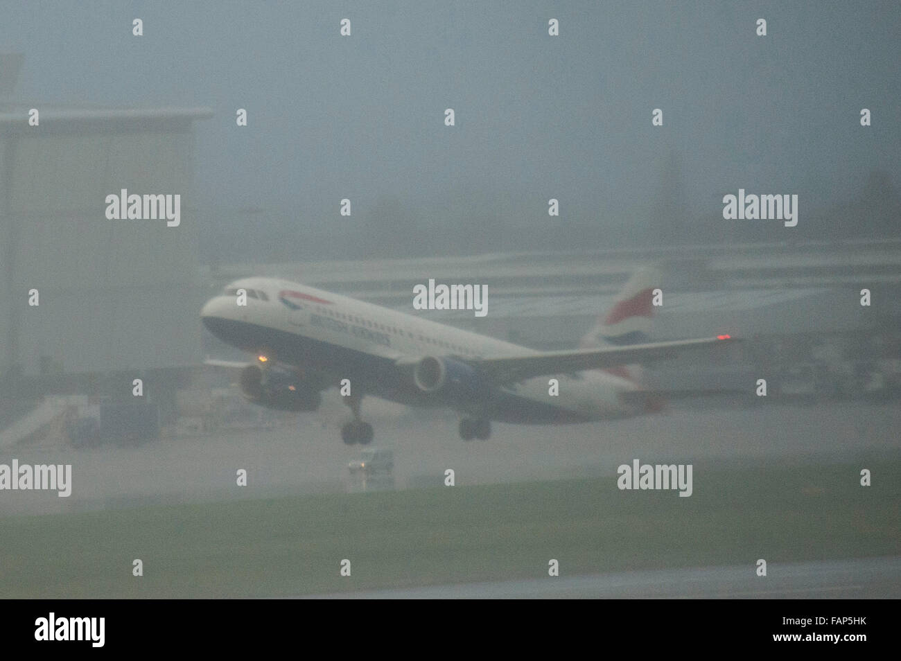 London, UK, 02 January 2016, Planes continue to take off in heavy rain and mist at Heathrow Airport as storm Frank causes floods in the north of England. Credit:  JOHNNY ARMSTEAD/Alamy Live News Stock Photo