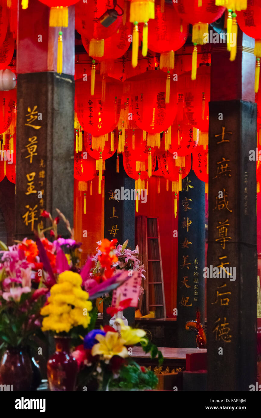 Red lanterns and flowers inside Cixian Temple dedicated to Matsu in Shilin, Taipei, Taiwan Stock Photo