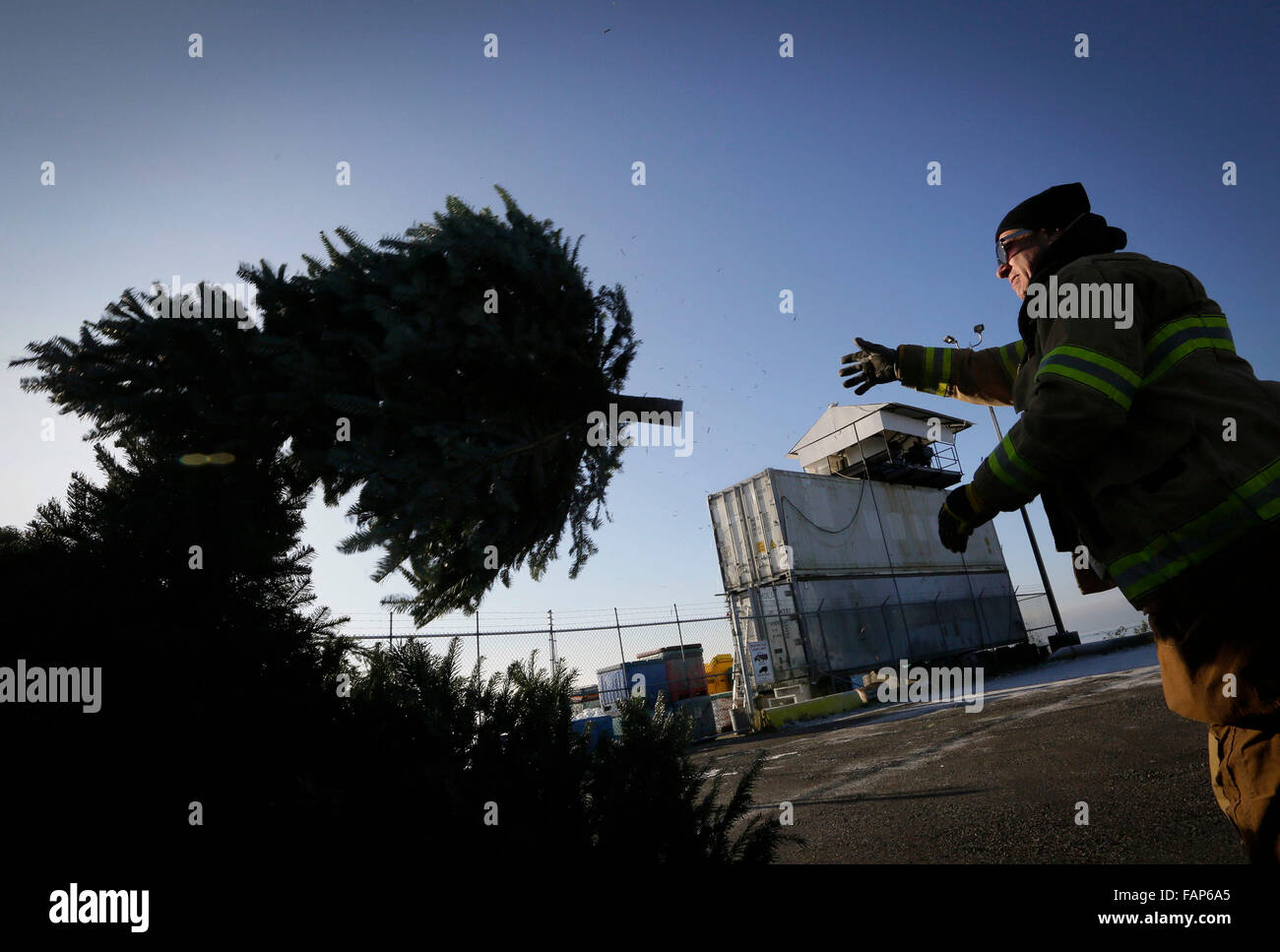 Vancouver, Canada. 2nd Jan, 2016. A firefighter gathers up Christmas