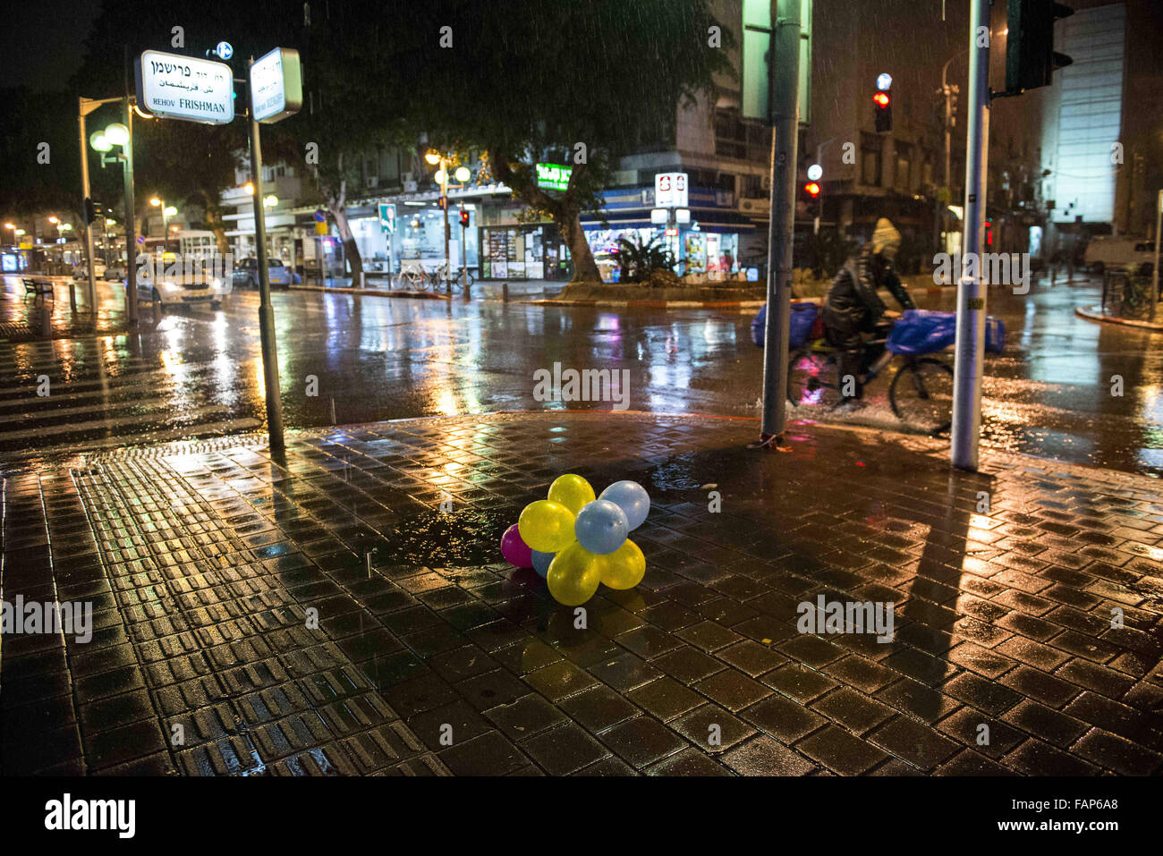 Tel Aviv, Israel, Israel. 2nd Jan, 2016. The crime scene a day later; Balloons left out from the new years parties at Dizengoff street at a rainy night. Credit:  Danielle Shitrit/ZUMA Wire/Alamy Live News Stock Photo