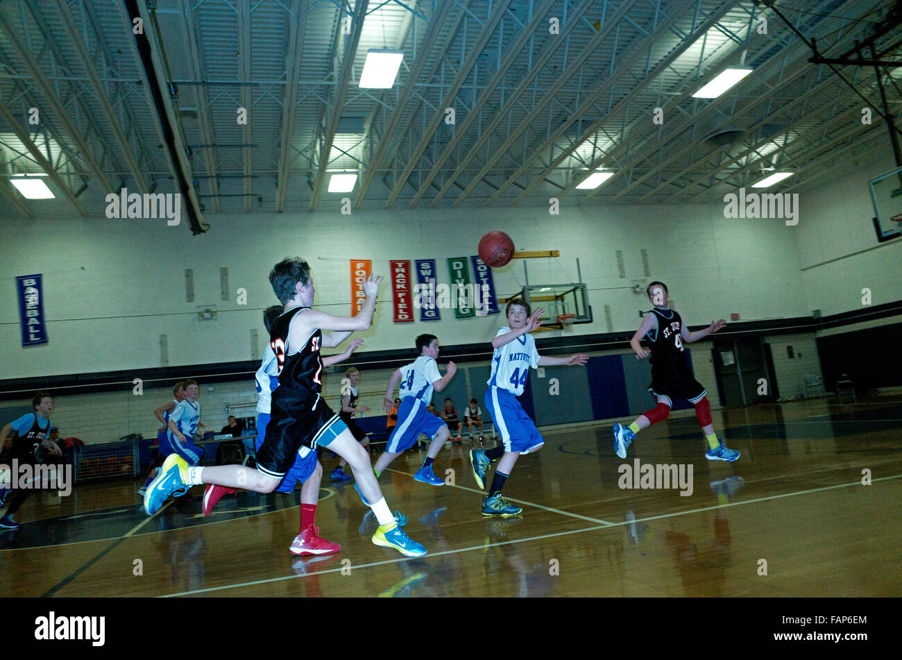 Boys age 12 playing a vigorous game of indoor basketball. St Paul