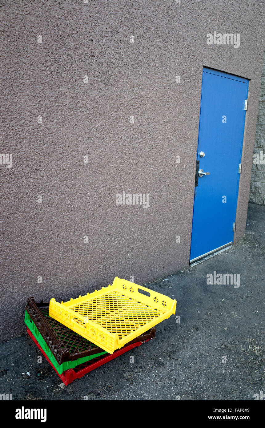 Stack Of Multicolored Plastic Racks Outside Of Blue Door St