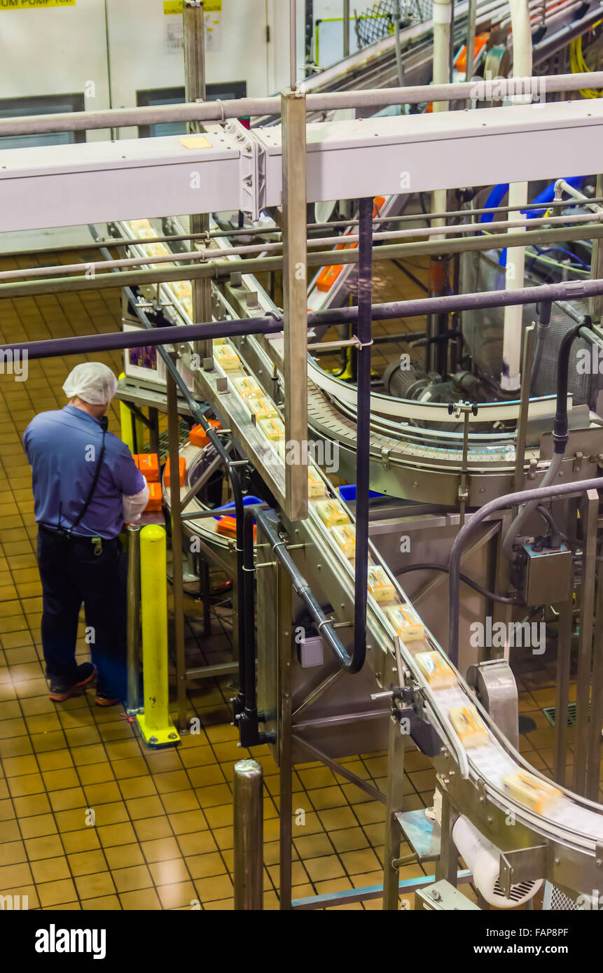 Workers prepare cheese for packaging and shipping at the Tillamook