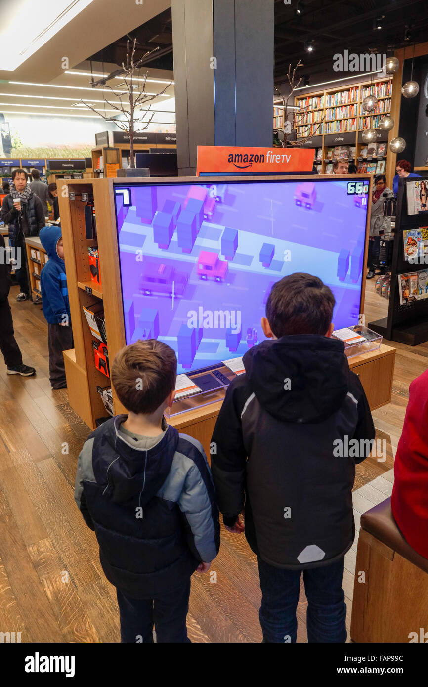 boys watching video game on fire tv, Amazon Books bricks and mortar store, University Village, Seattle, Washington State, USA Stock Photo