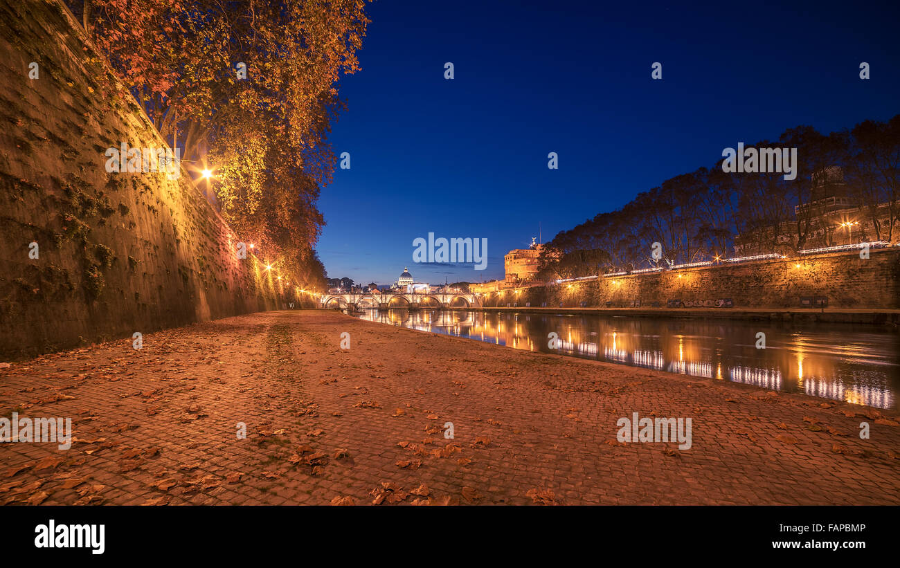 Autumn leaves on embankment of Tiber River in Rome, Italy Stock Photo