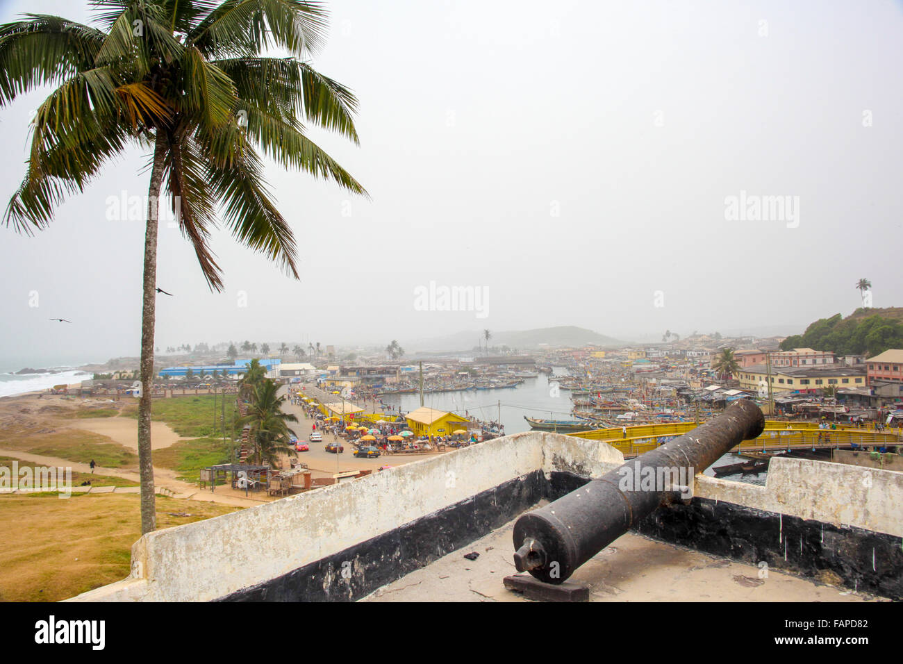Canons overlooking the old slavery town of Cape Coast in Ghana from the clave fort. Stock Photo