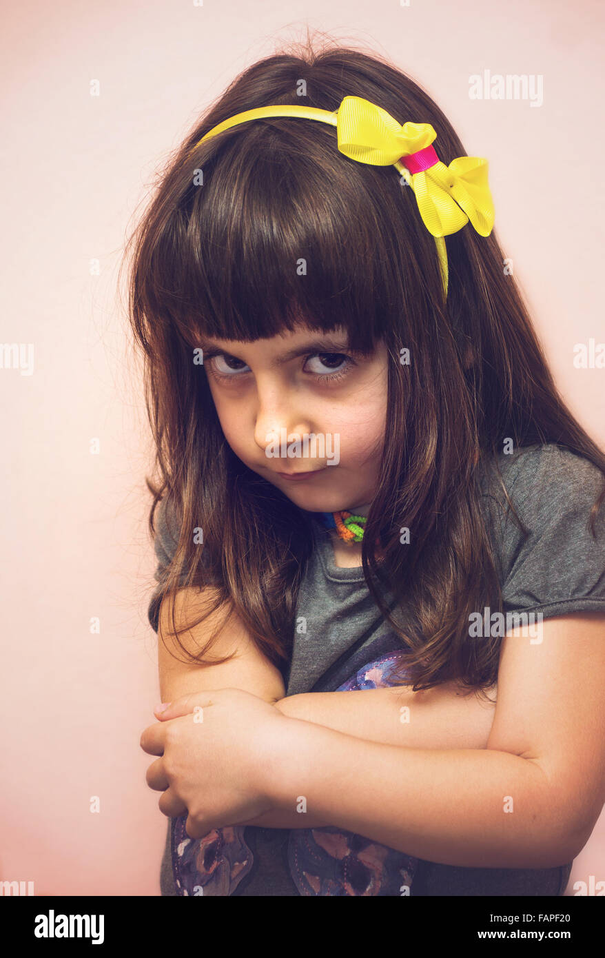 Angry child girl portrait at home in soft tones Stock Photo