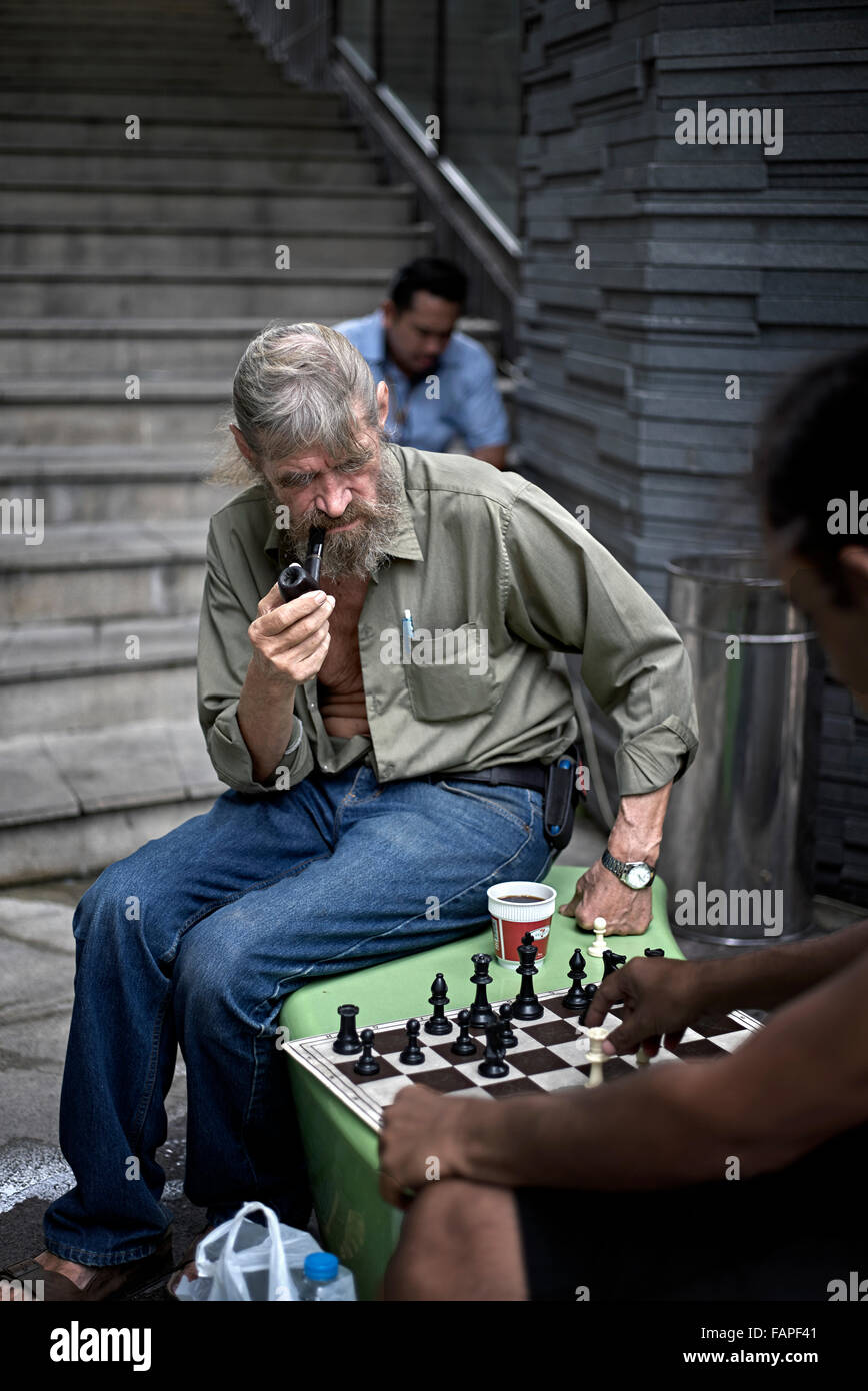 Chess game with pipe smoking player Stock Photo Alamy