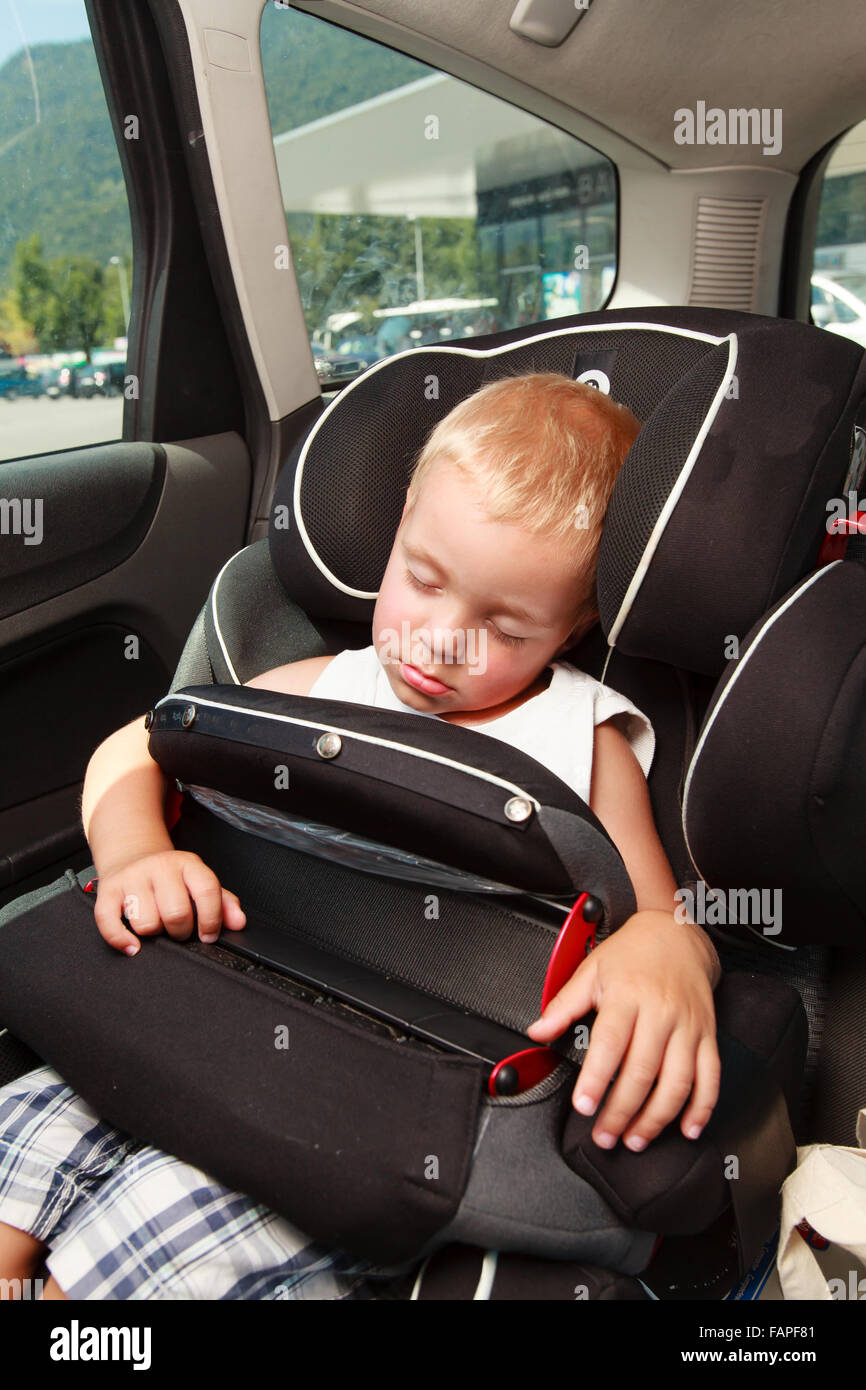 Little boy sleeping in car seat safety Stock Photo Alamy