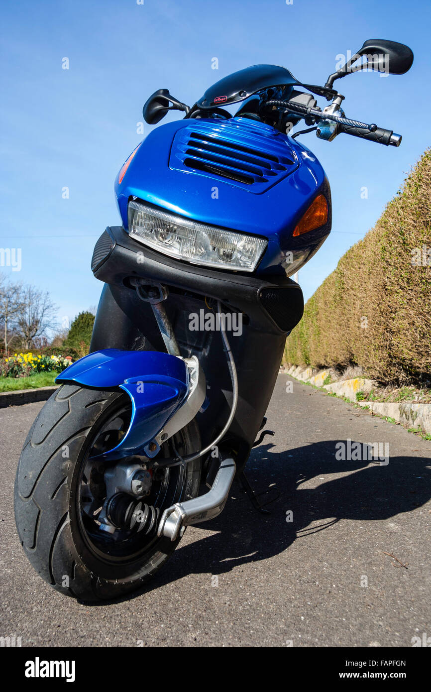 Motor scooter, Italjet Dragster 180 classic bike. Low wide angle front view  of front wheel and headlight. Clear blue sky and hedge background Stock  Photo - Alamy