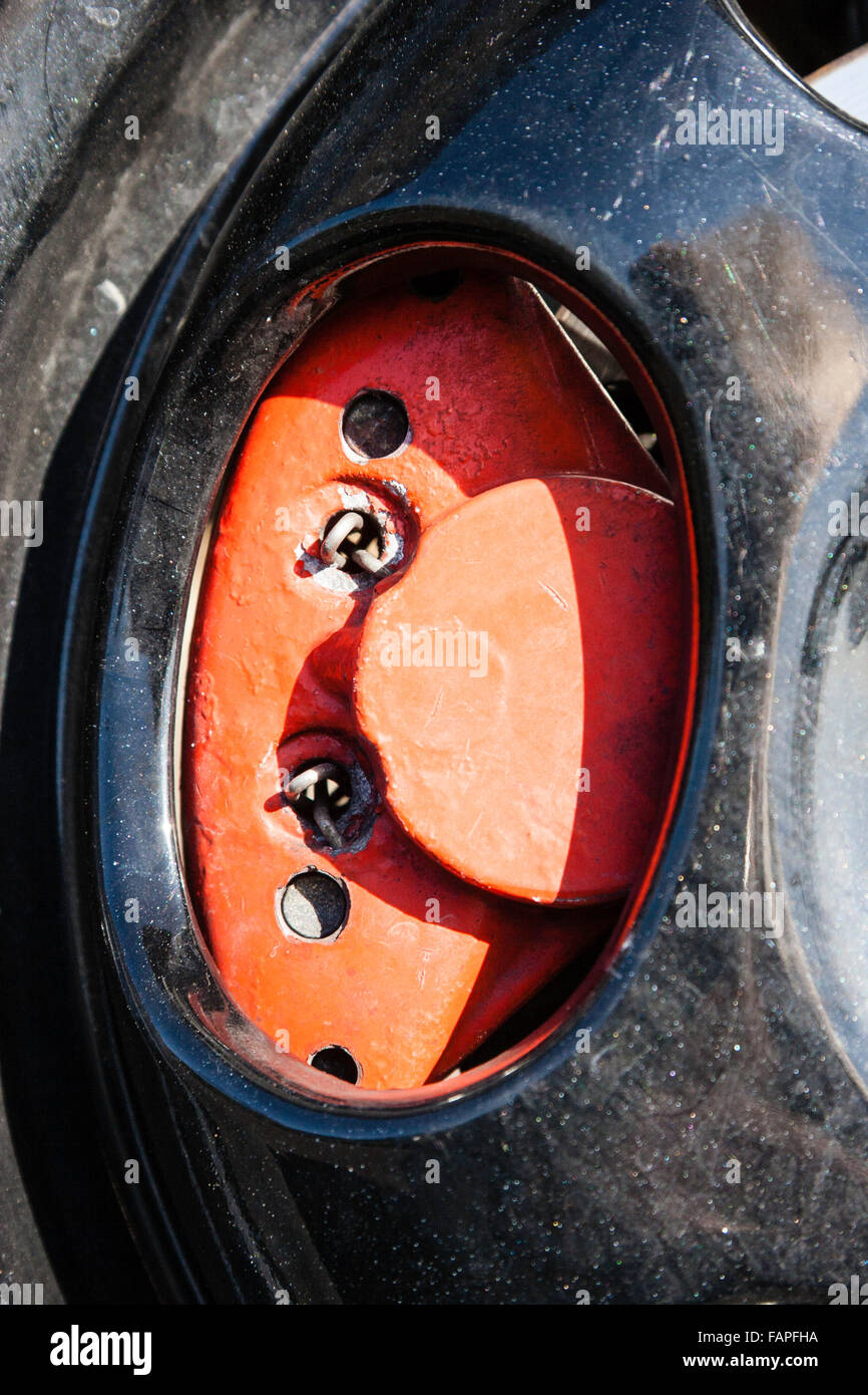 Motor Scooter, Italjet Dragster. Close up of red front brake seen through black wheel hub. Stock Photo