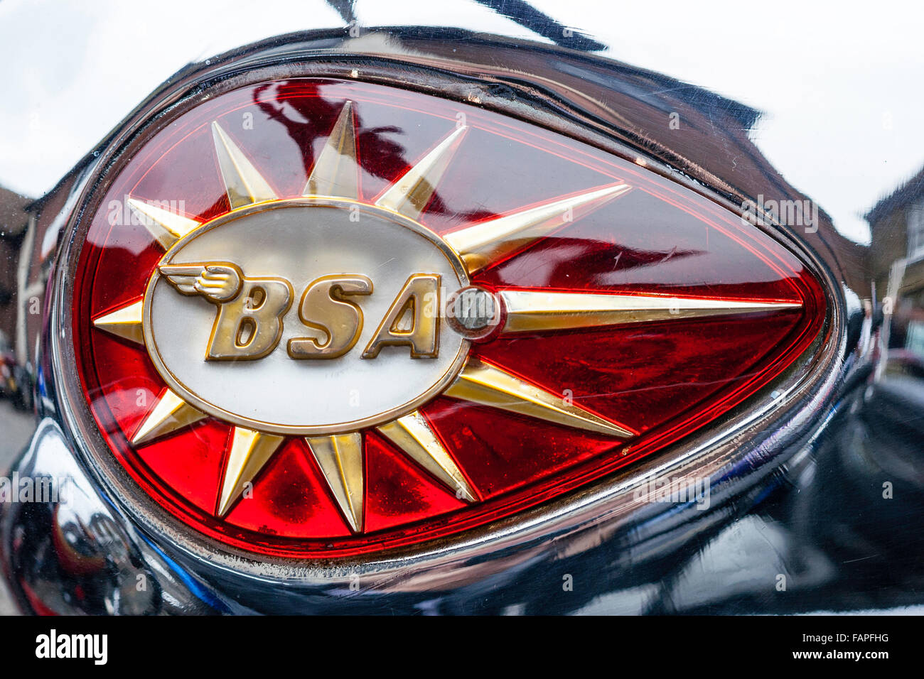 Close up of gold and red BSA emblem. BSA embossed on shooting star. Shiny and reflective. Stock Photo