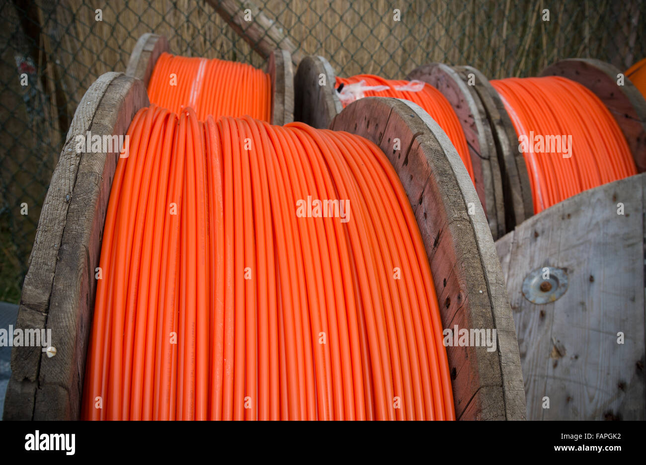 HENGELO, NETHERLANDS - MARCH 28, 2015: Drums with orange fiber cable owned by Reggefiber, a Dutch company that specializes in th Stock Photo