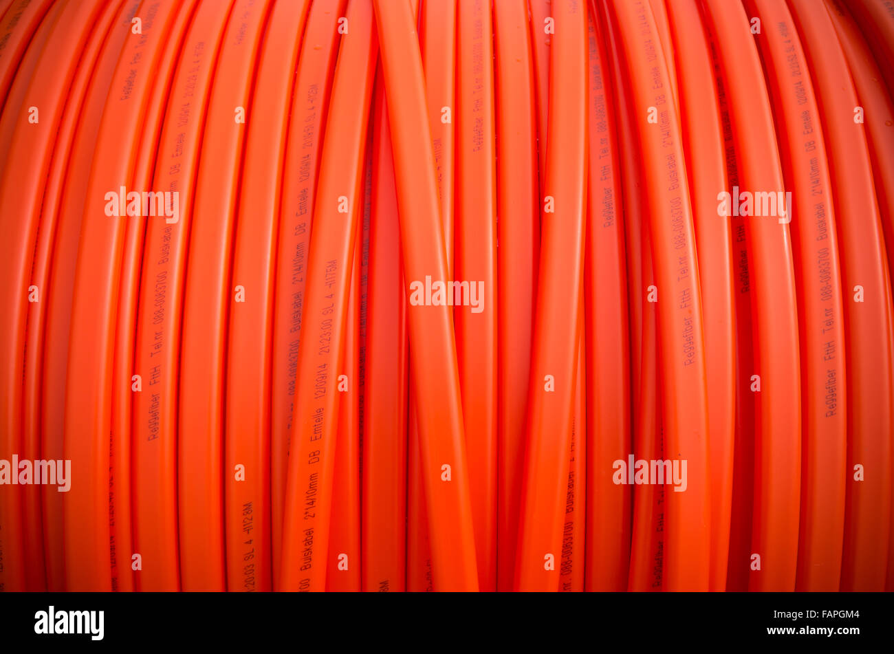 HENGELO, NETHERLANDS - MARCH 28, 2015: Closeup of orange fiber cable owned by Reggefiber, a Dutch company that specializes in th Stock Photo