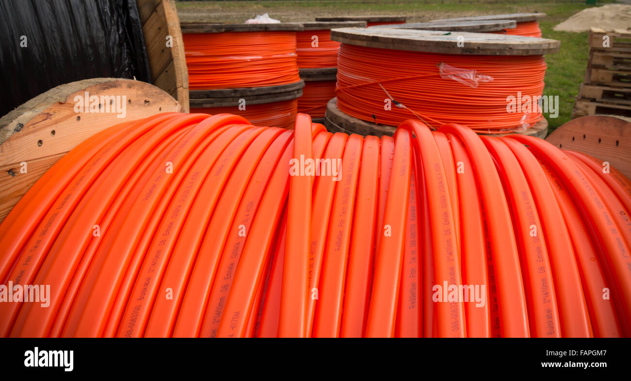HENGELO, NETHERLANDS - MARCH 28, 2015: Drums with orange fiber cable owned by Reggefiber, a Dutch company that specializes in th Stock Photo