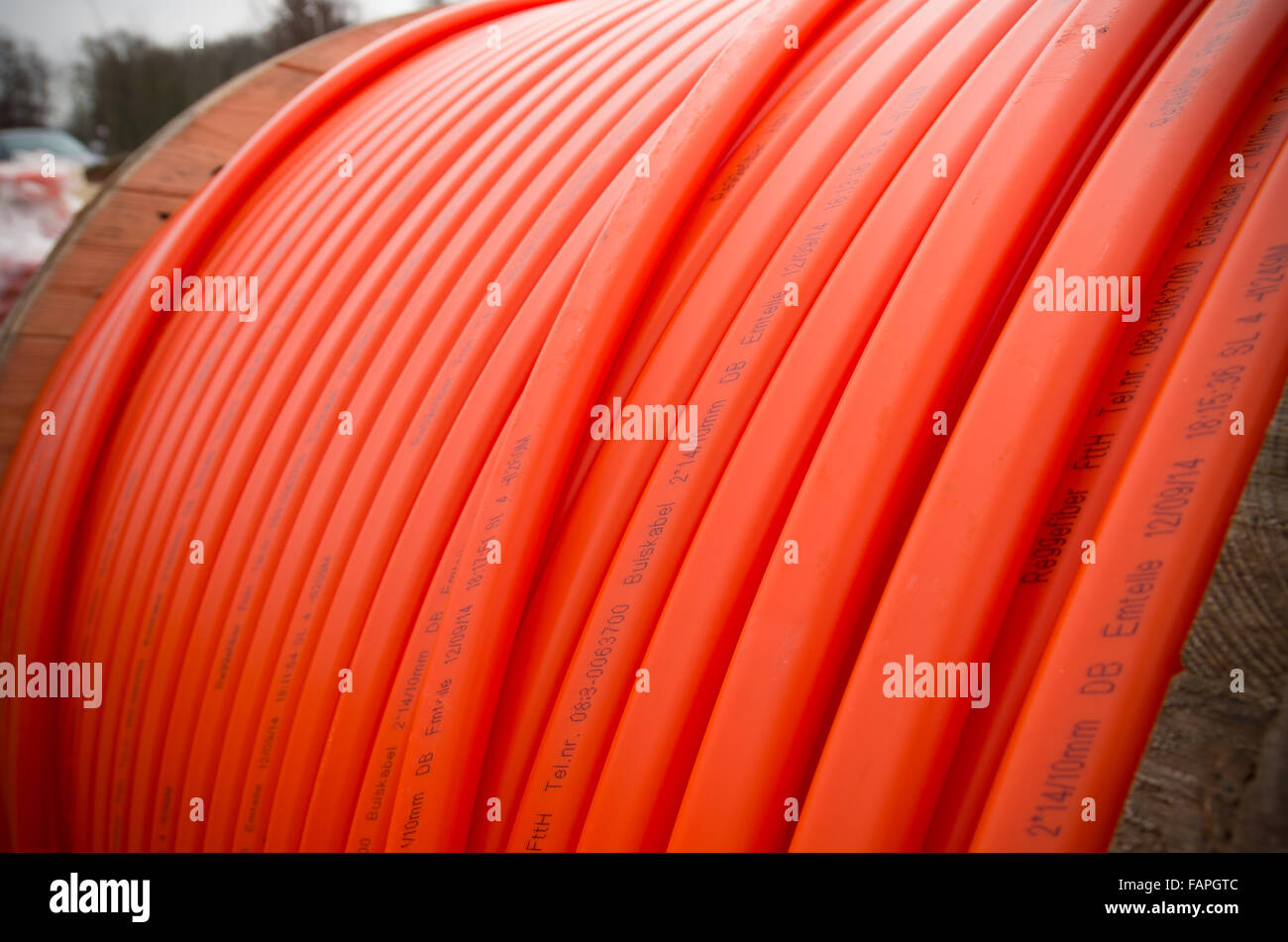 HENGELO, NETHERLANDS - MARCH 28, 2015: Orange fiber cable owned by Reggefiber, a Dutch company that specializes in the installat Stock Photo