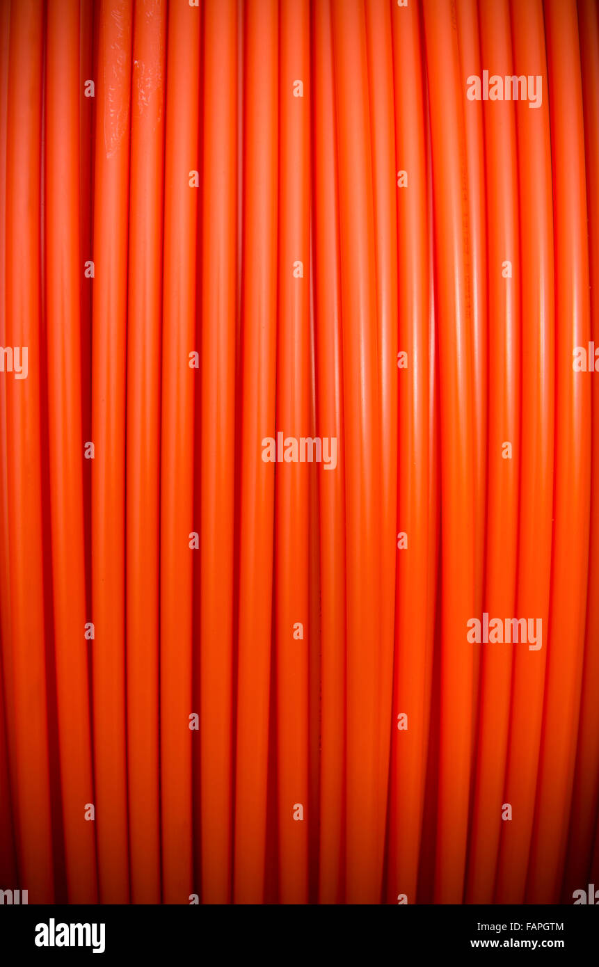 background of a roll of orange fiber cable Stock Photo