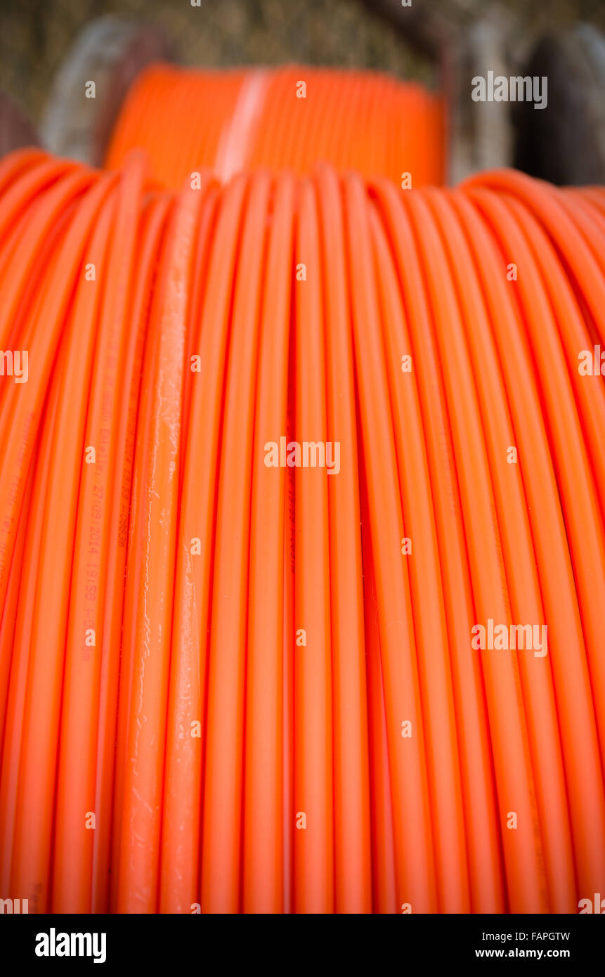 cable drums with orange fiber cable on a construction site Stock Photo