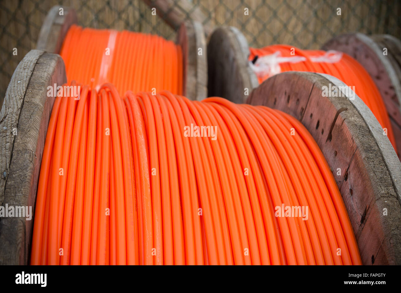 cable drums with orange fiber cable on a construction site Stock Photo