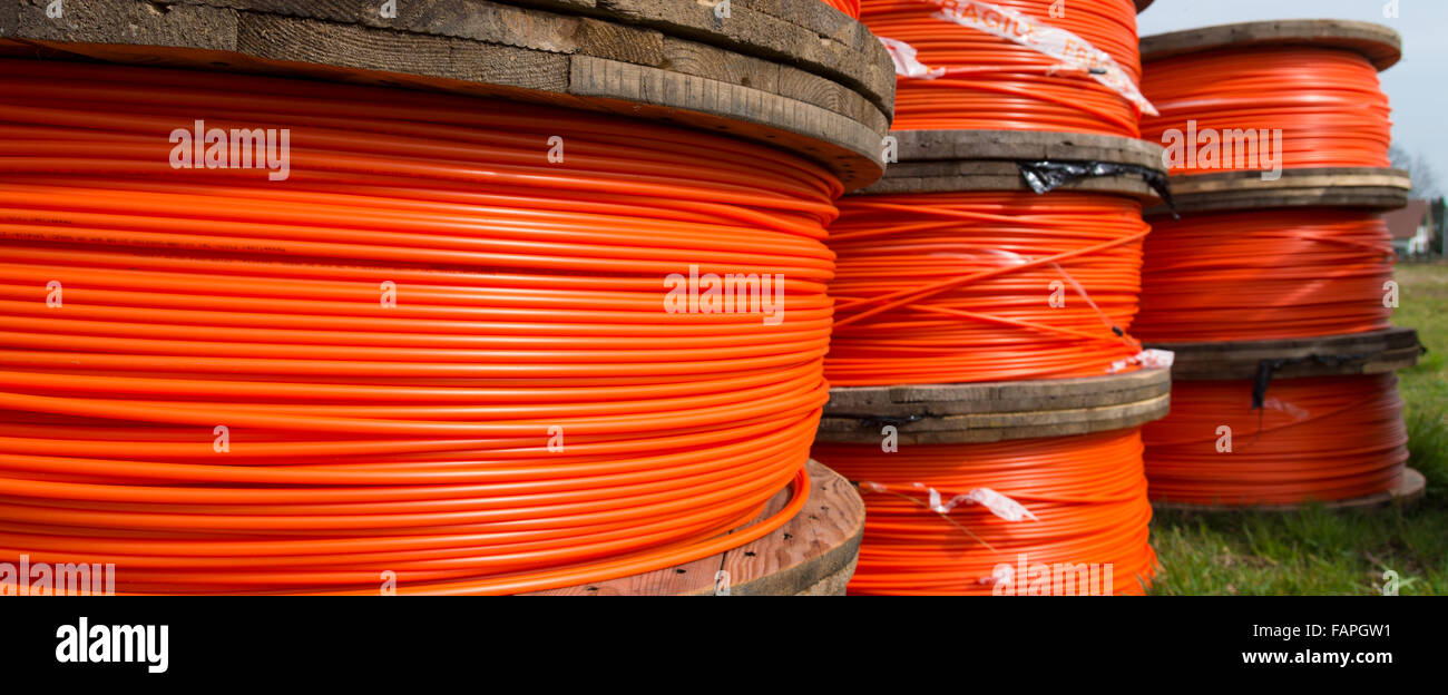 cable drums with orange fiber cable on a construction site Stock Photo