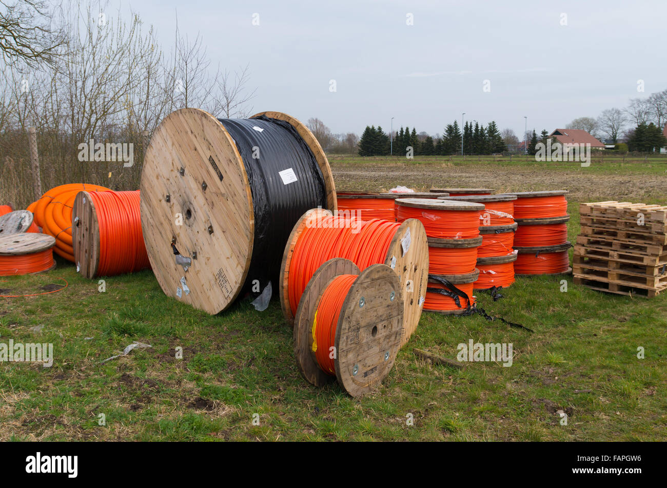 cable drums with orange fiber cable on a construction site Stock Photo