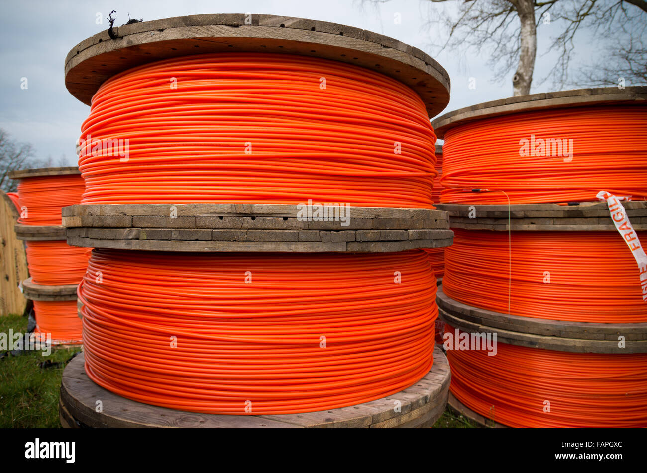 large drums with orange fiber cables on a construction site Stock Photo