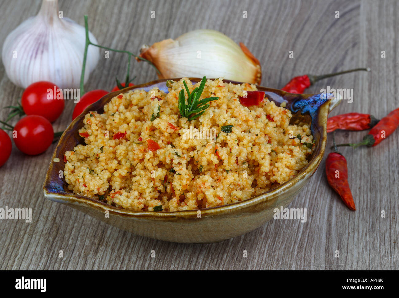 Arabic traditional cuisine Couscous with tomato and green onion Stock