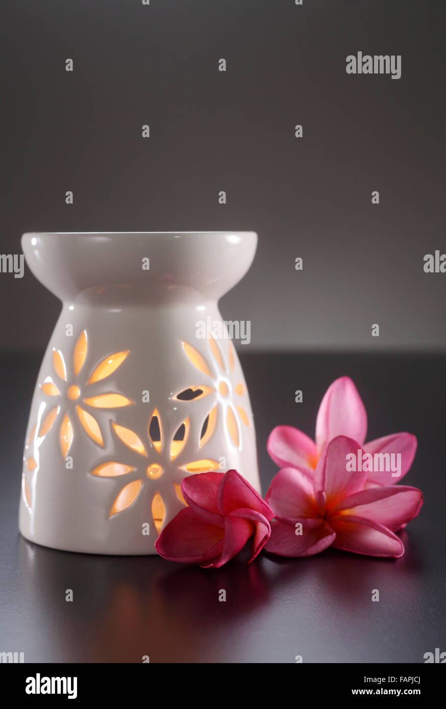 oil burner with the frangipani flower by the side Stock Photo
