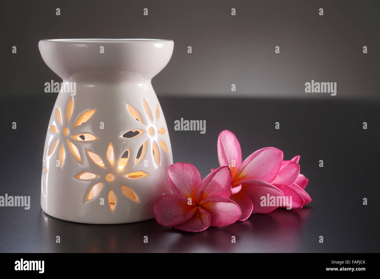 oil burner with the frangipani flower by the side Stock Photo