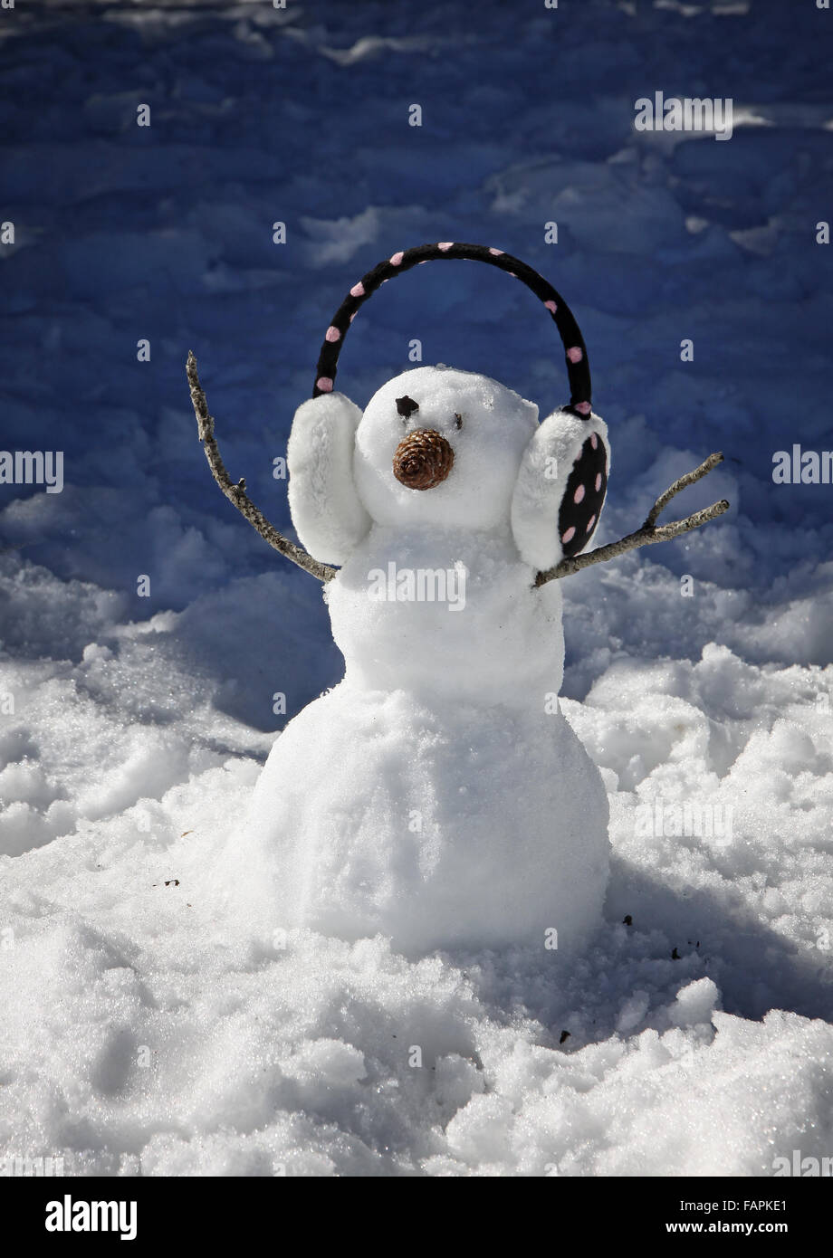 Small funny snowman with headphone Stock Photo