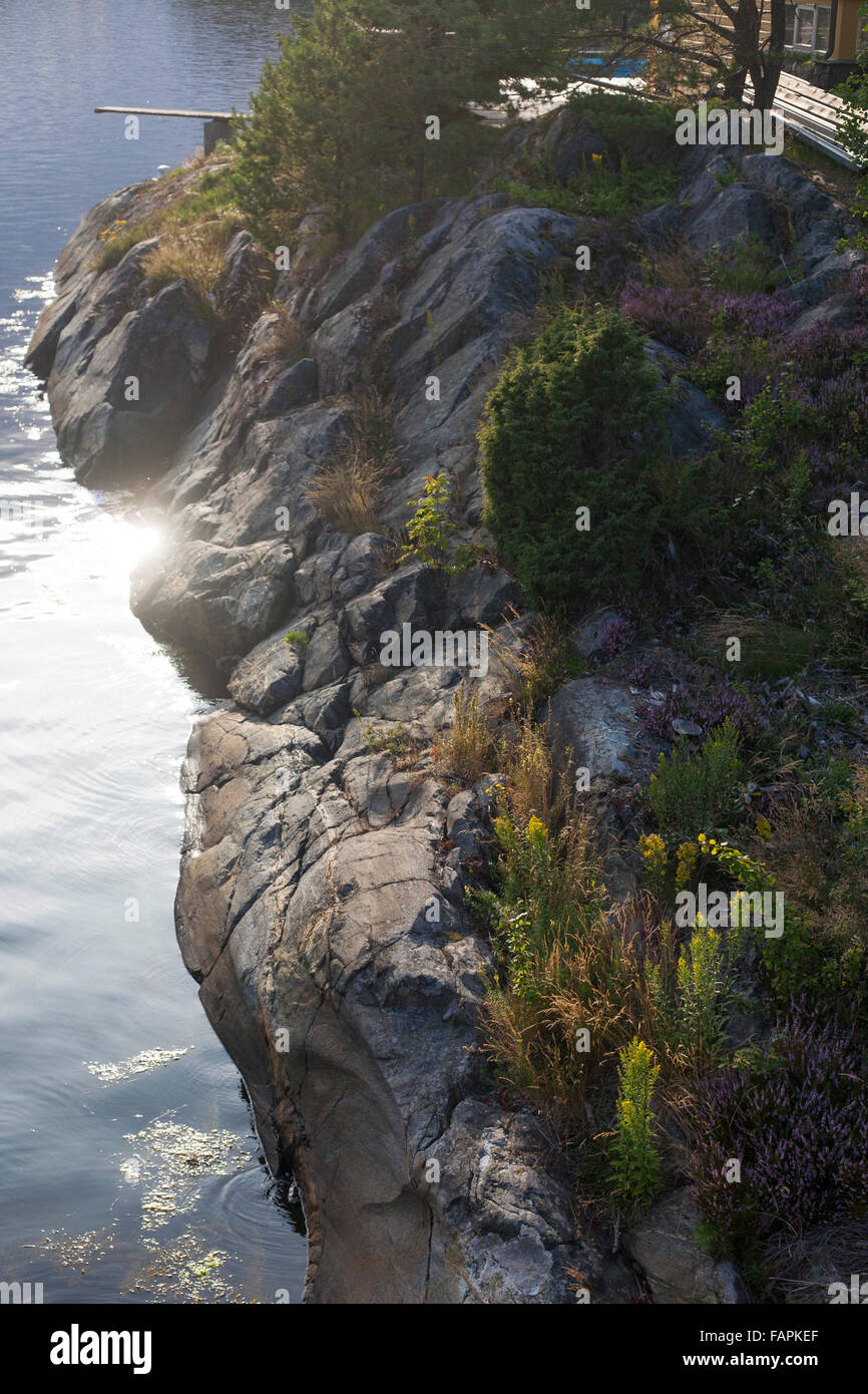 Sunlight reflecting off fjord, with diving board Risøy, Kragerø, Norway Stock Photo