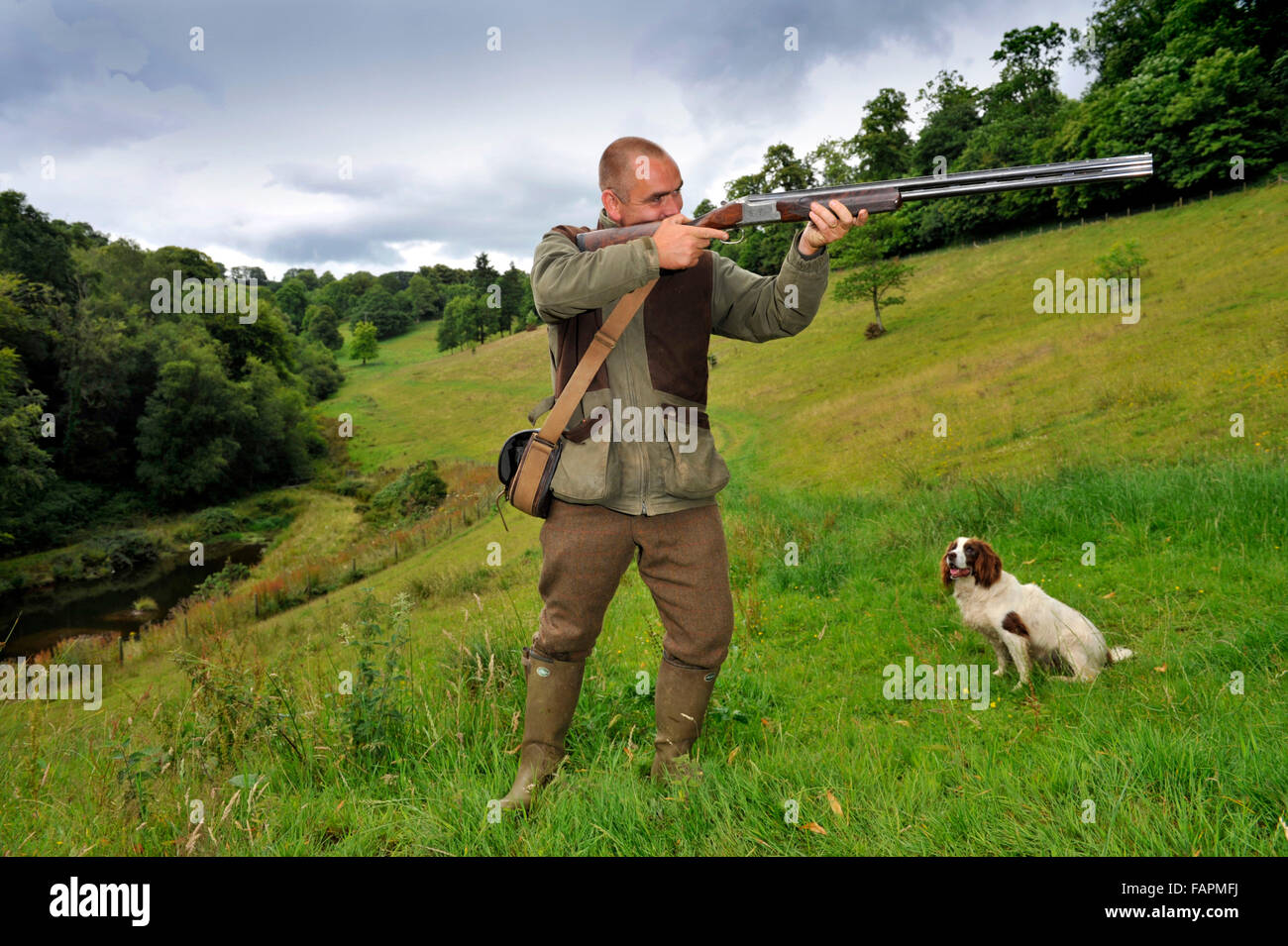 Darren Ninnis,gamekeeper with shotgun and dogs and a retained