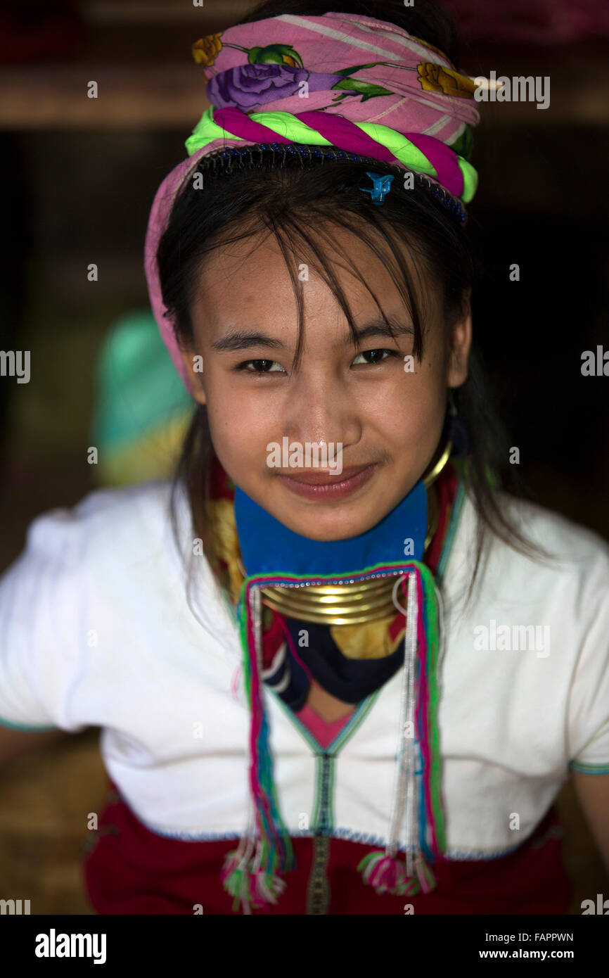 A woman from the Kayan tribe weaving in a workshop at Inle Lake in Myanmar (Burma). The woman wears brass coils on her neck. Stock Photo
