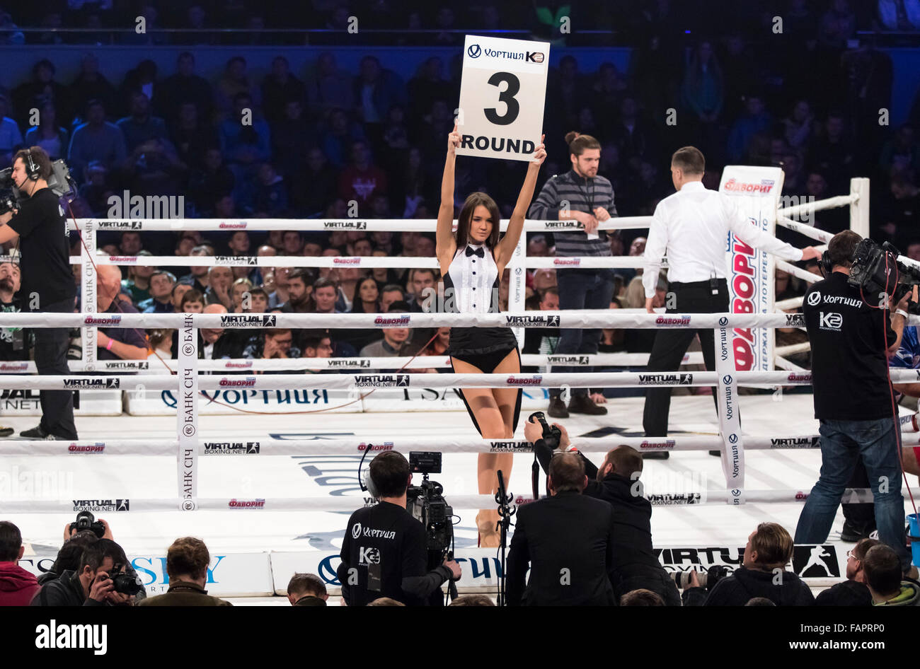 KYIV, UKRAINE - DECEMBER 12, 2015: Boxing ring girls holding a board with round number during WBO Intercontinental cruiserweight Title fight Oleksandr Usyk vs Pedro Rodriguez at Palace of Sports Stock Photo