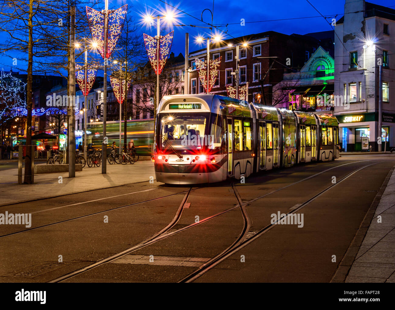 A Nottingham tram heads up Market Street in the market square at Christmas In Nottingham. Stock Photo