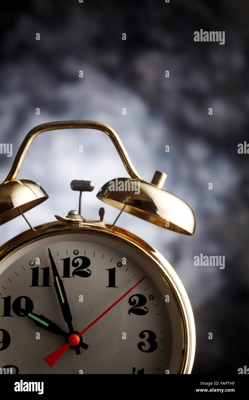 Old alarm clock isolated on the background Stock Photo - Alamy