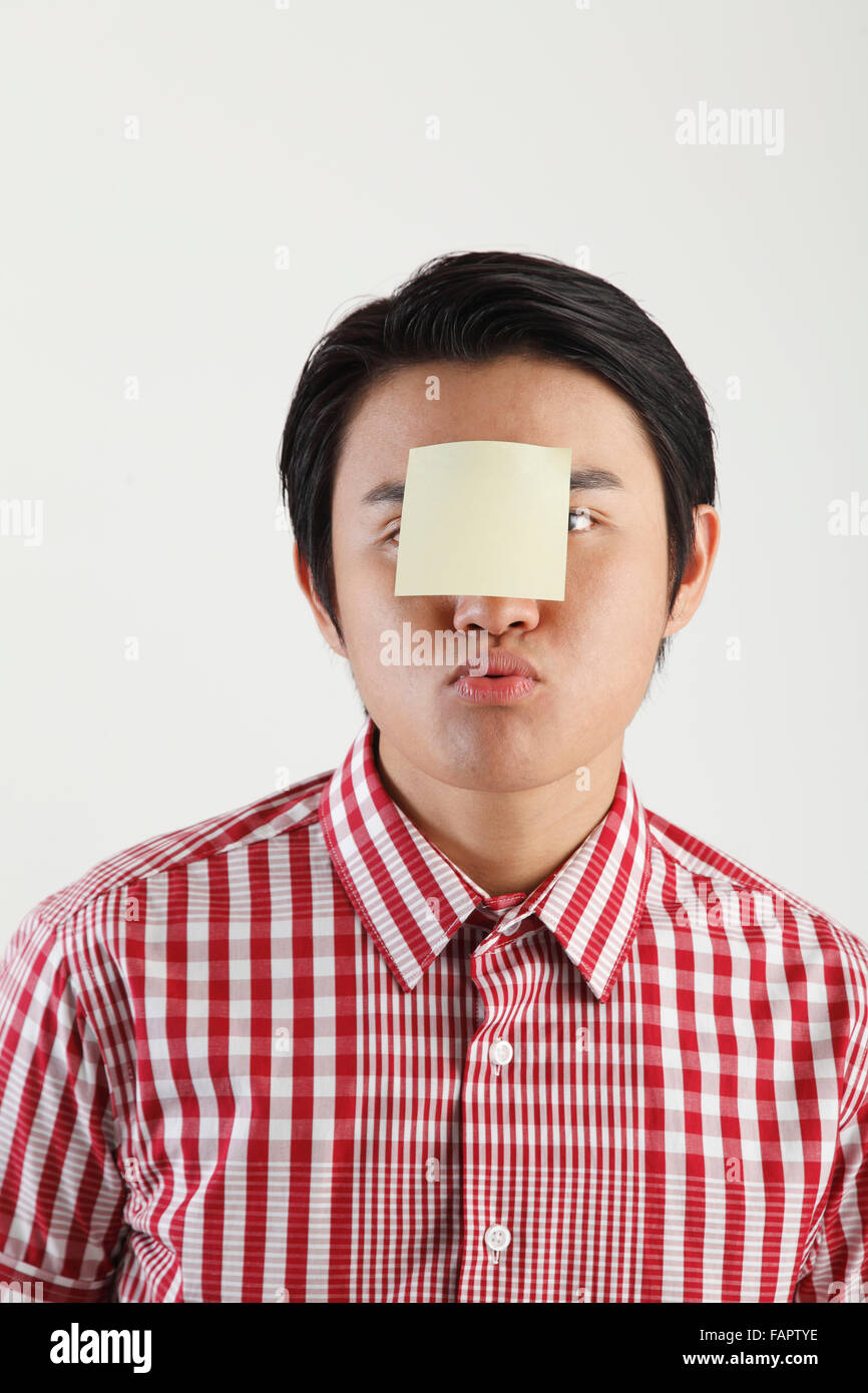 man with an adhesive note on his forehead Stock Photo