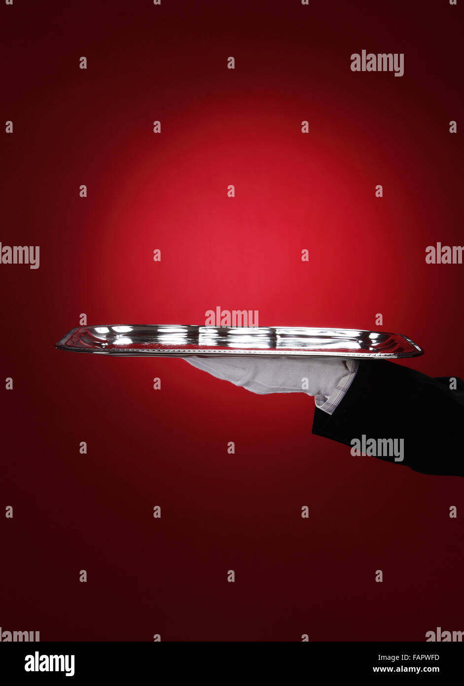 Butler carrying silver serving tray, close-up of hand Stock Photo