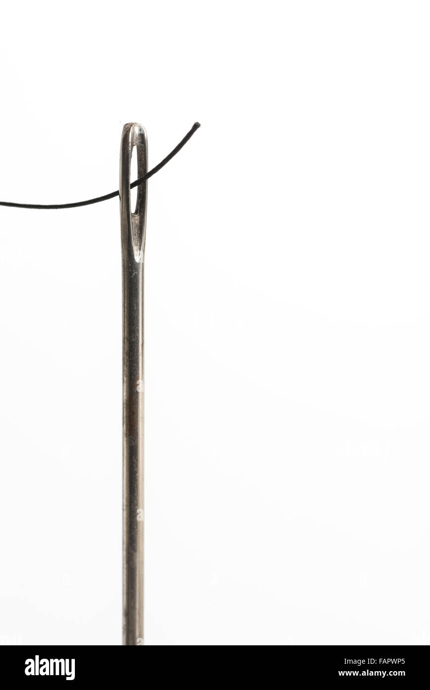 cotton and thread inserted through needle eye steel sewing reel of thin