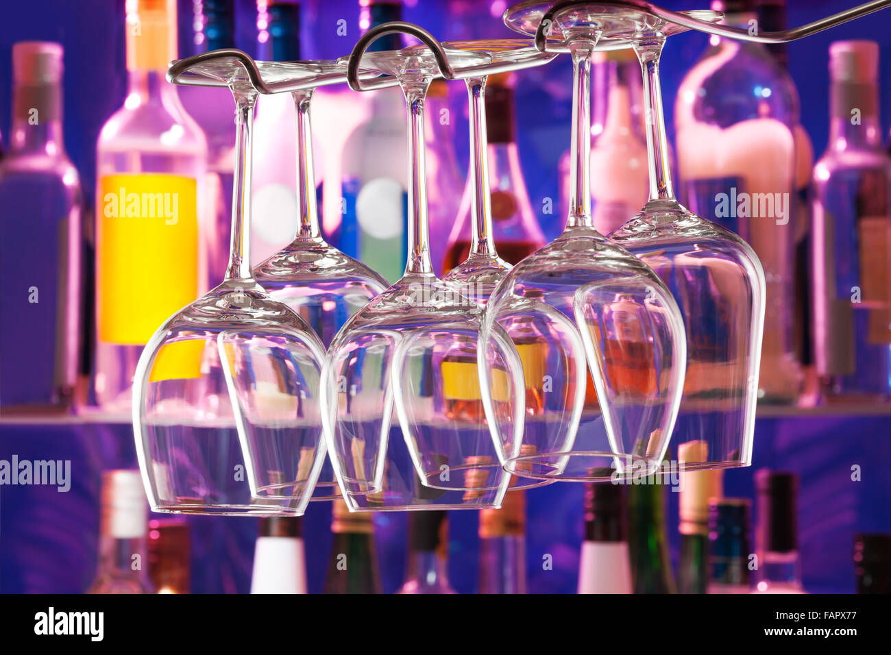 Different set of glasses hanging in the bar Stock Photo