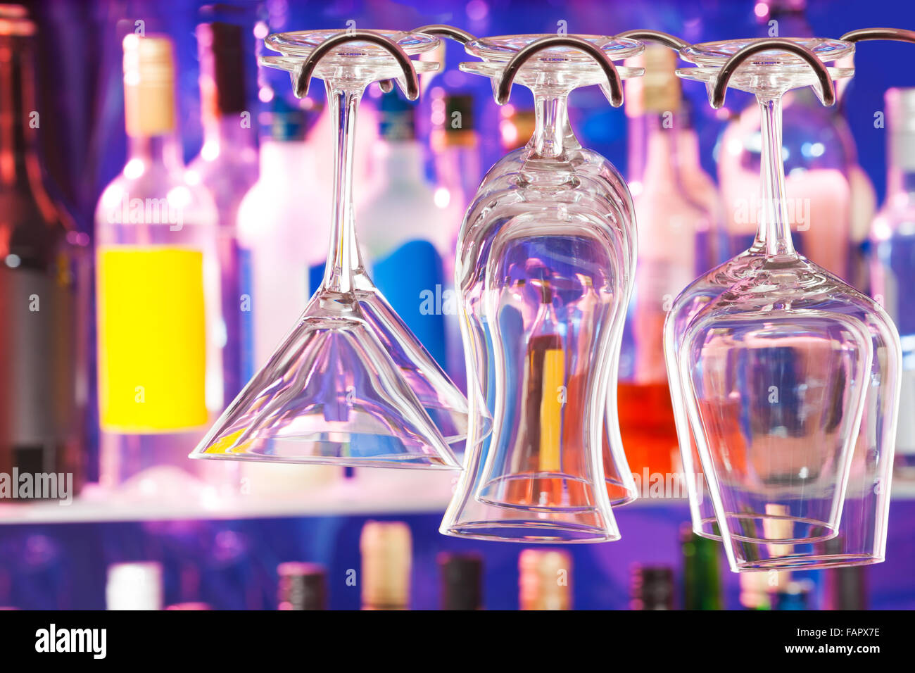 Different type of glasses on the hanger in bar Stock Photo