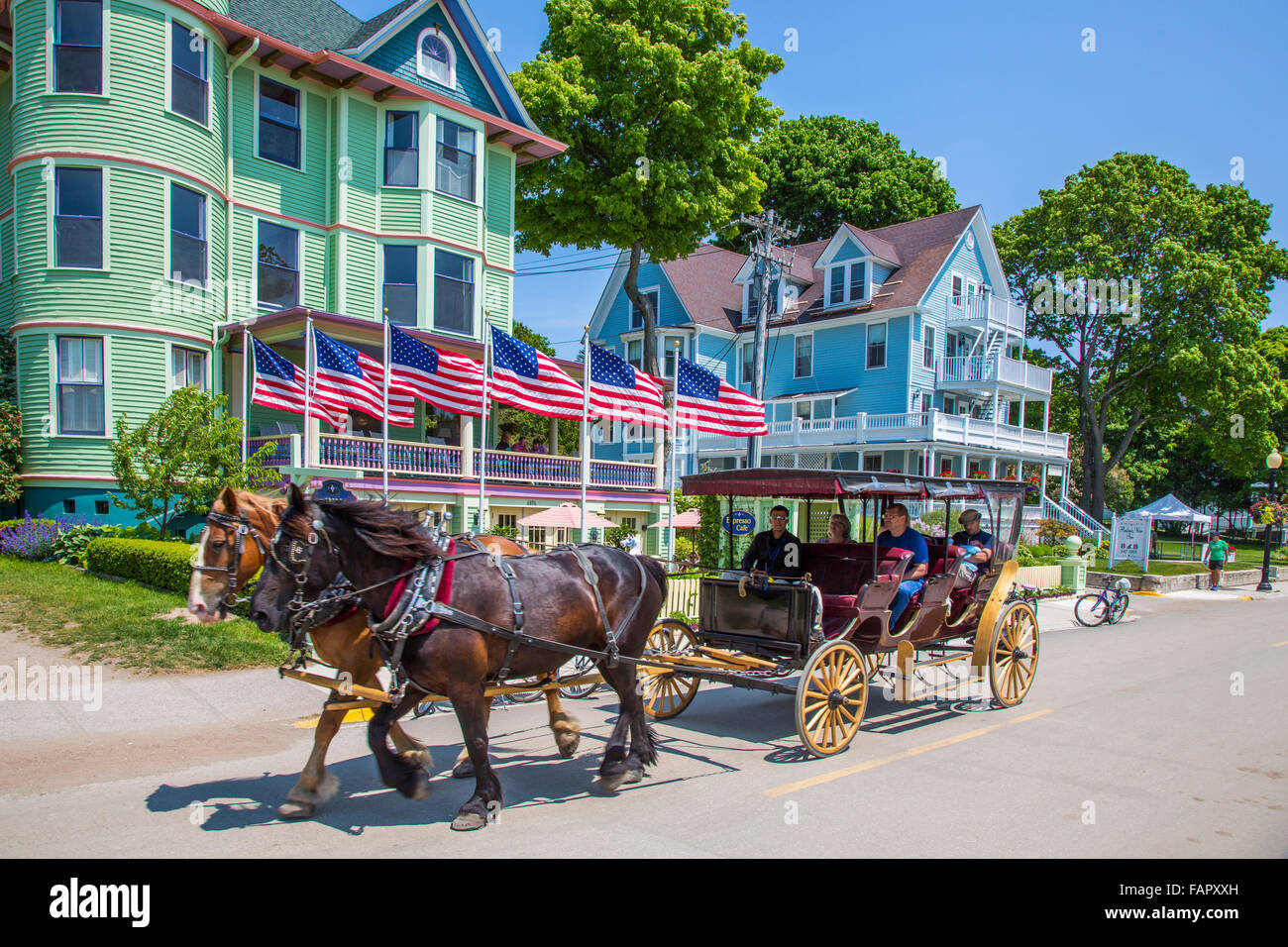 Tourists riding in horse carriage on resort island of Mackinac Island