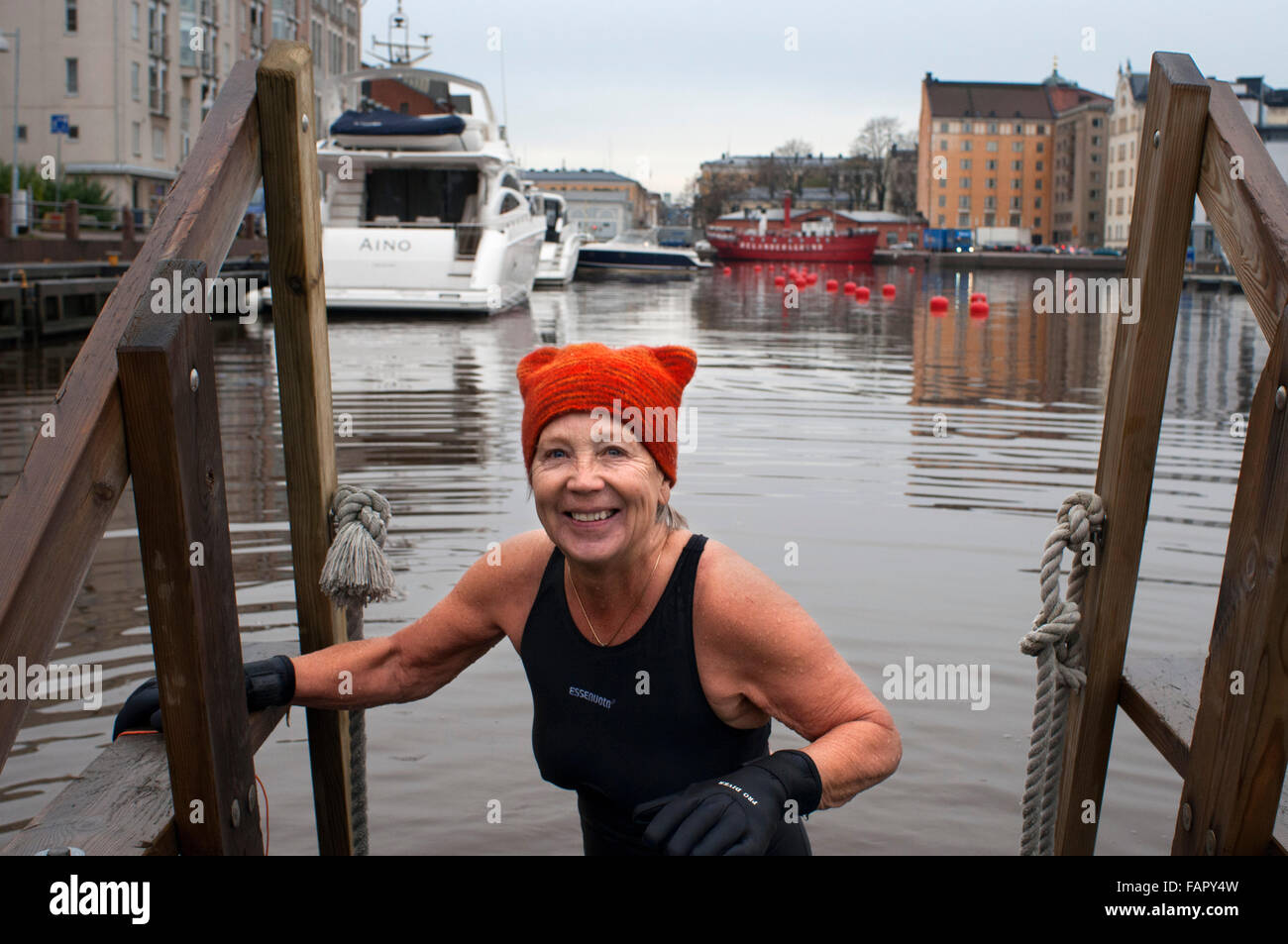 Helsinki. Katajanokka Guest Harbour Pier north of Katajanokka, Helsinki, Finland. An elderly lady out of the water after a sauna Stock Photo