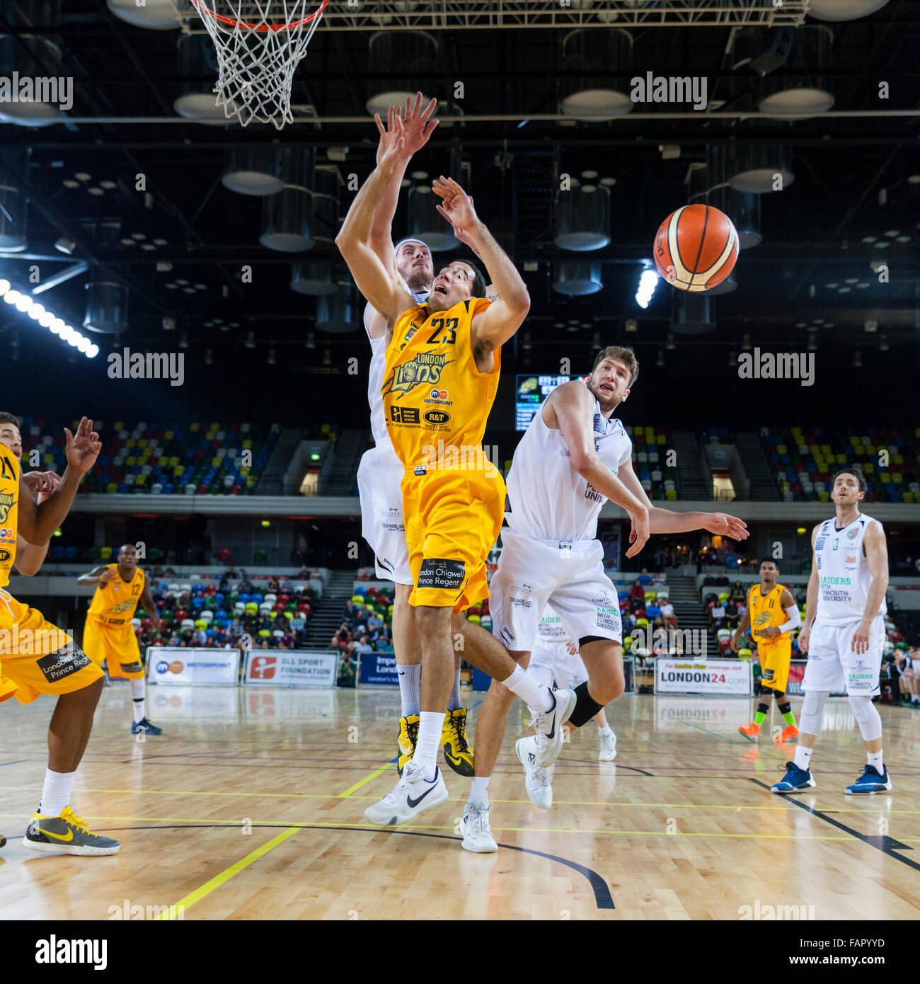 London, UK. 3rd January 2016. London Lions player Kai Williams (23) is kept  from following through at the basket by the Plymouth defense, during the  London Lions vs. Plymouth Raiders BBL game