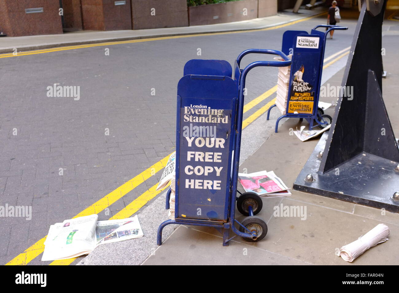 Evening Standard branded trollies with newspapers in at an entrance to Liverpool Street station. Stock Photo