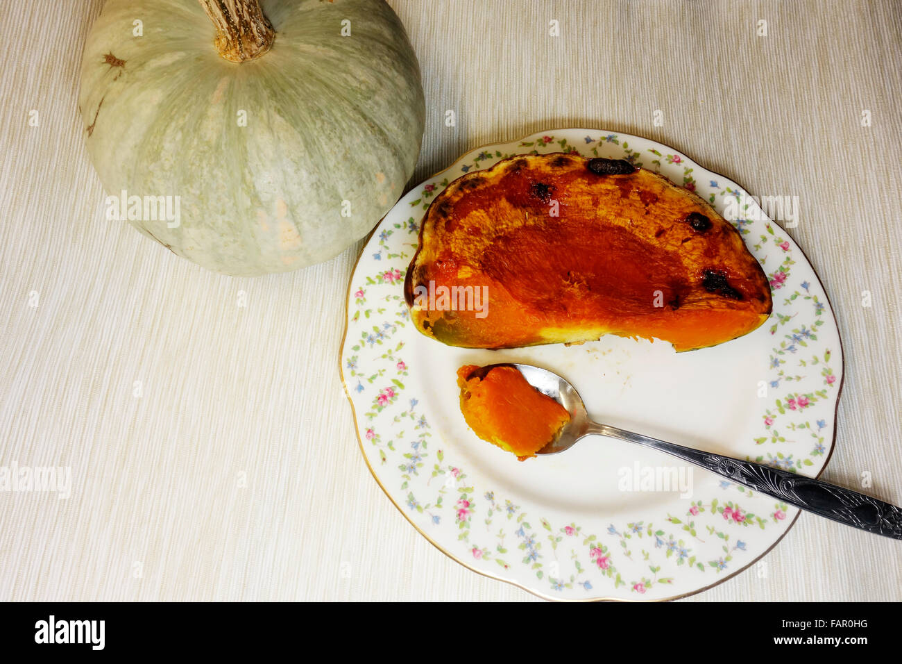 Oven baked Sweet  'Kroshka' a winter squash. A slice served on a white saucer Stock Photo