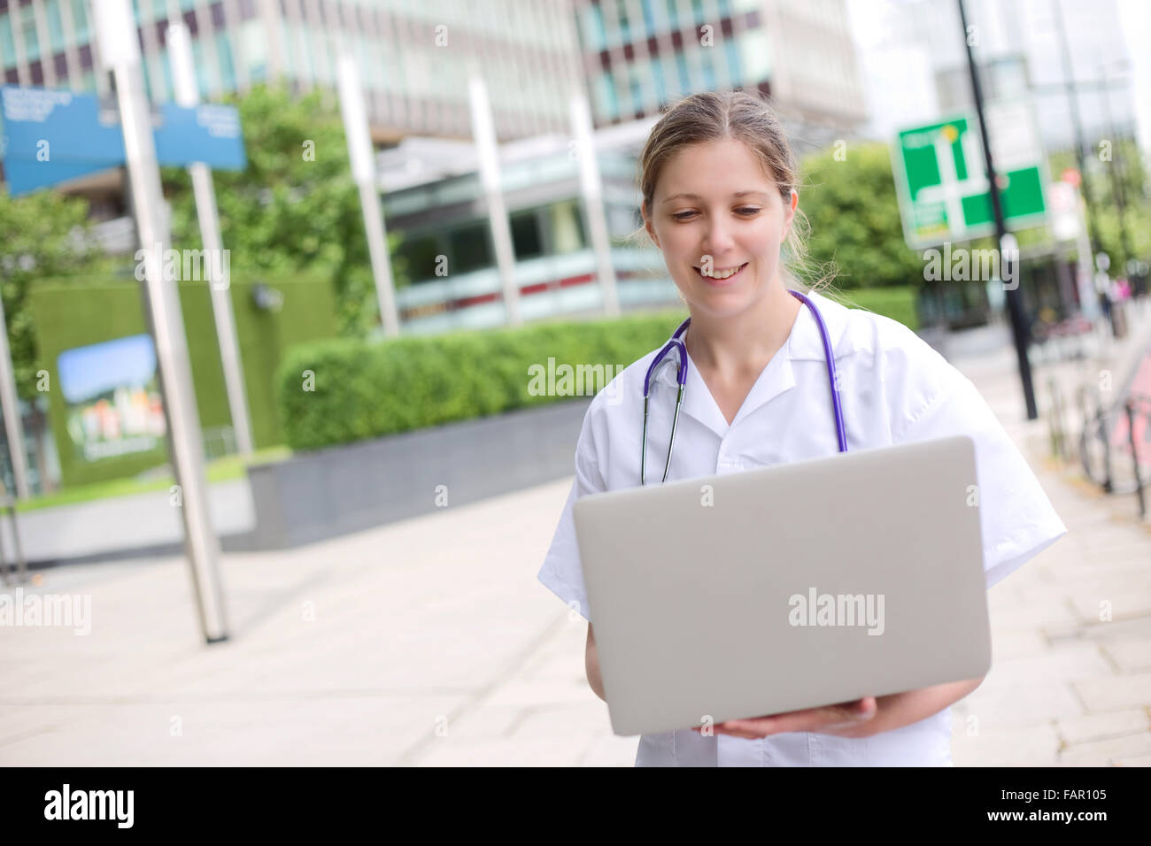 young doctor holding a laptop computer Stock Photo