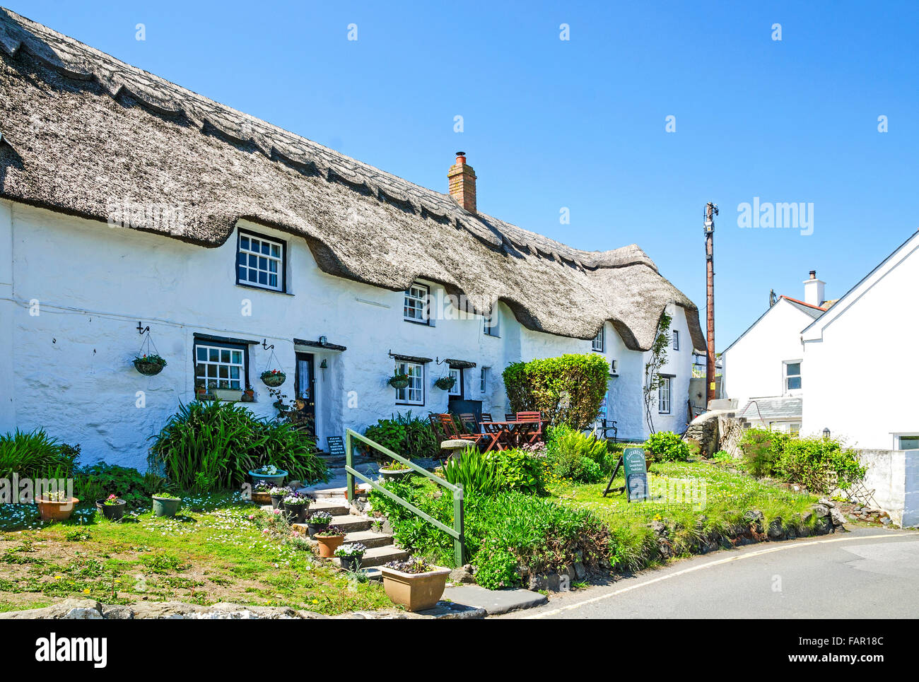A traditional thatched roof cottage at Coverack in Cornwall, England, UK Stock Photo